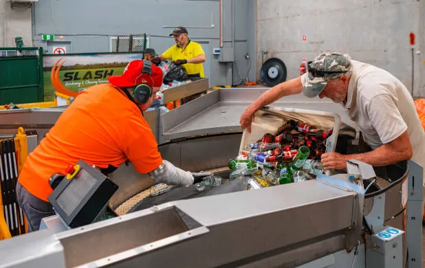 CDS Bottle recycling onto conveyor belt