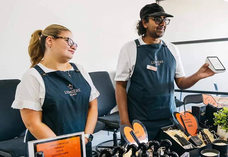 Lumiere staff members using point of sale machine for sale
