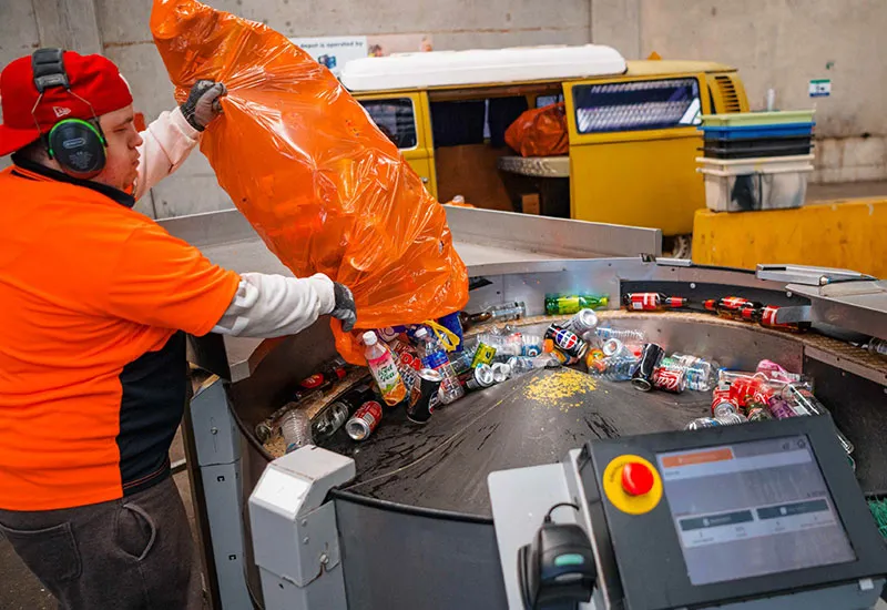 Hone's container recycling depot. Customer unloading a huge amount of containers onto conveyor belt
