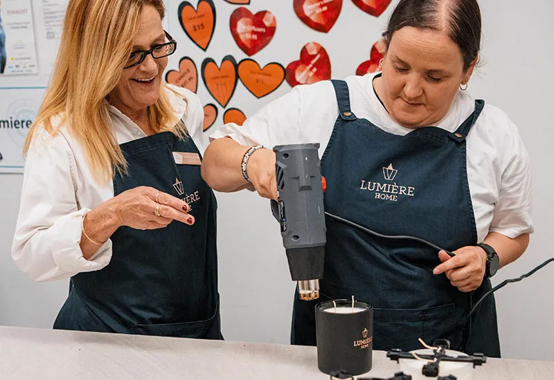 Lumiere employee creating candles for future sale