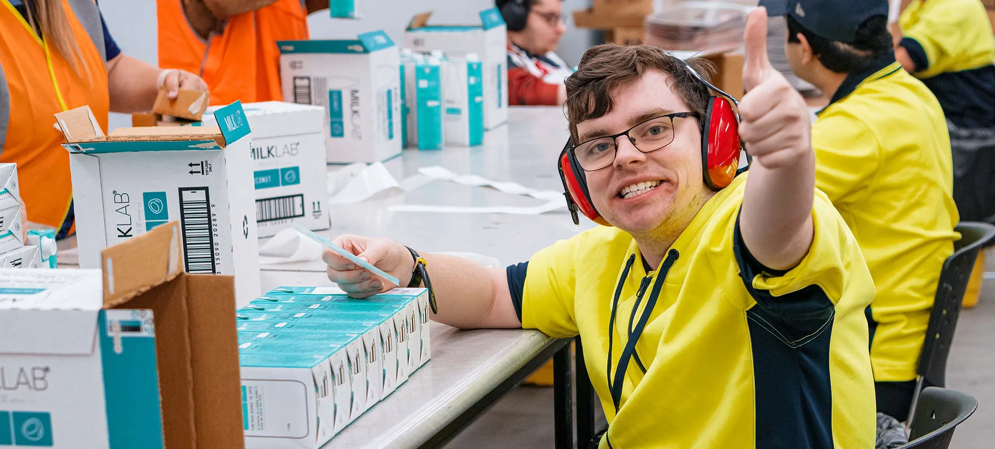 Hone supported employee in warehouse packing items for distribution.