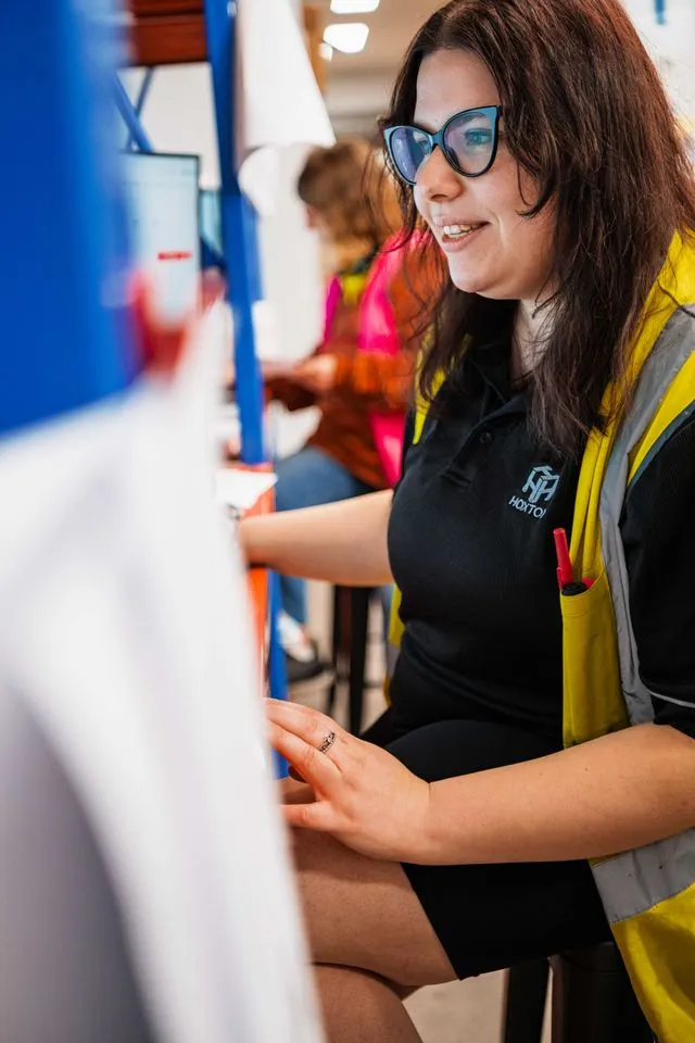 Hone supported worker in warehouse and laptop