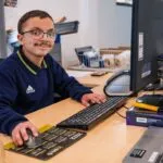 Hone supported employee on computer working