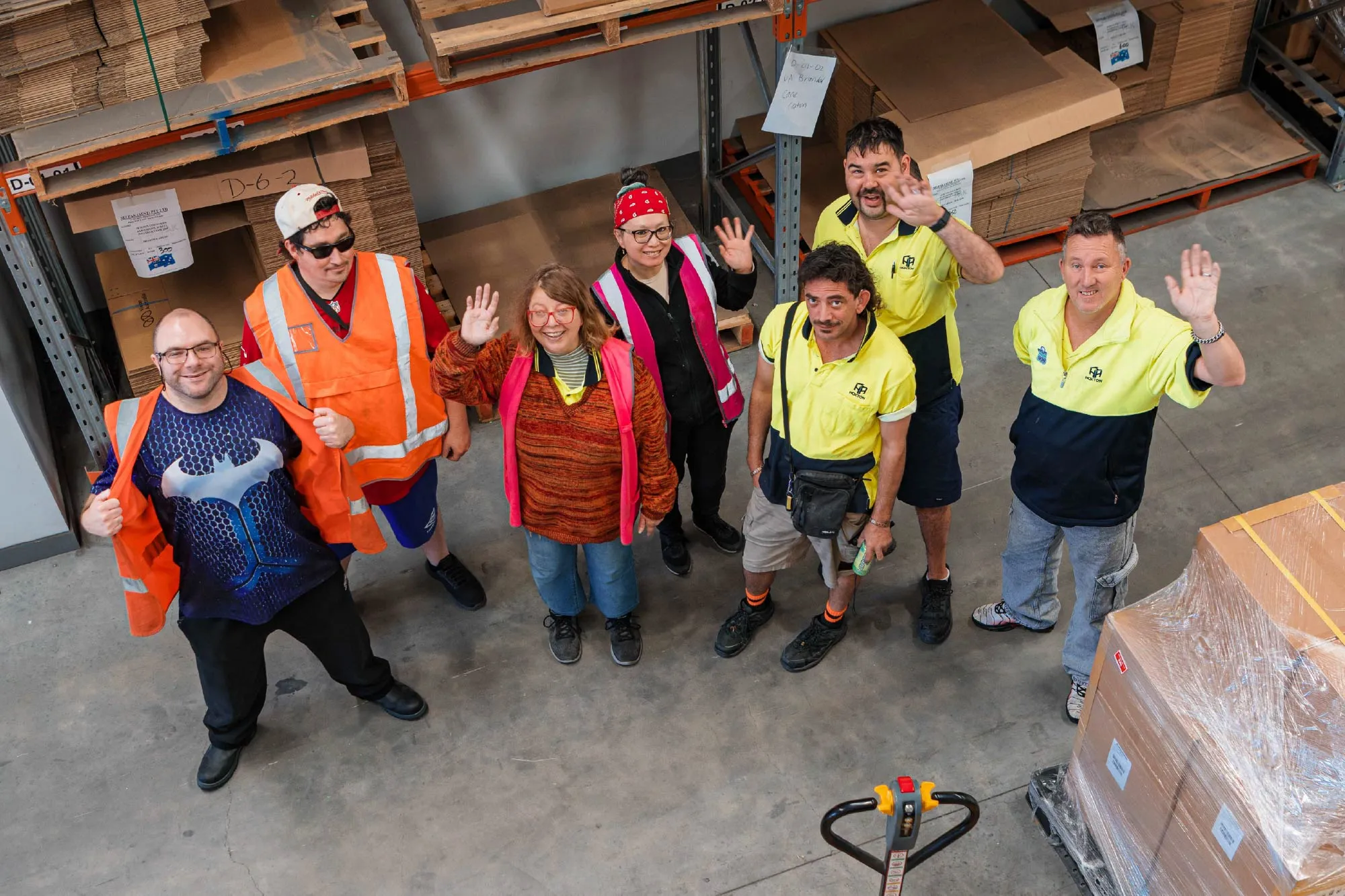 Multiple Hone supported employees standing around waving