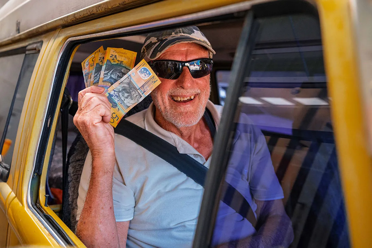 Hone Return & Earn cash back depots. Man holding cash