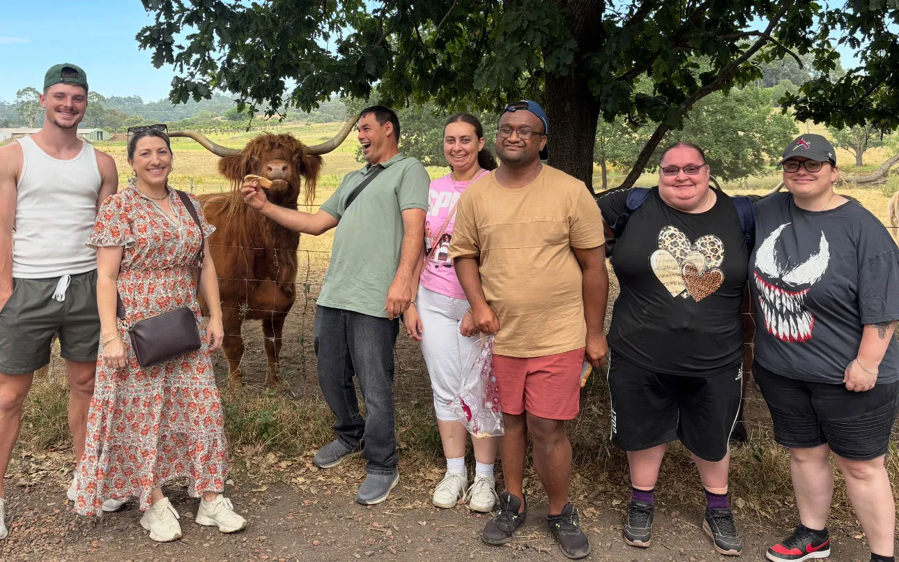 Hone supported workers hanging out with a cute cow on an outing