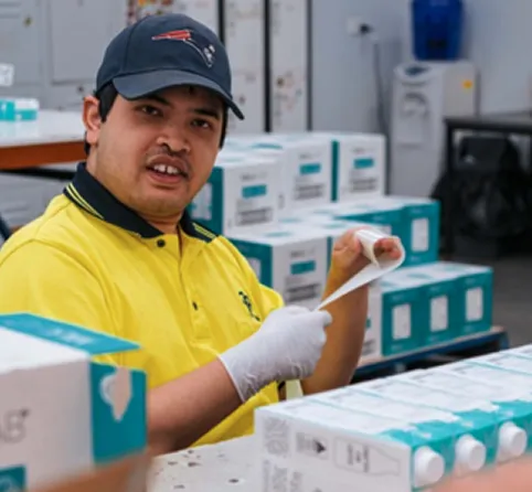 Hone employee working in factory holding order sheet