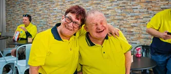 Supported employees hugging